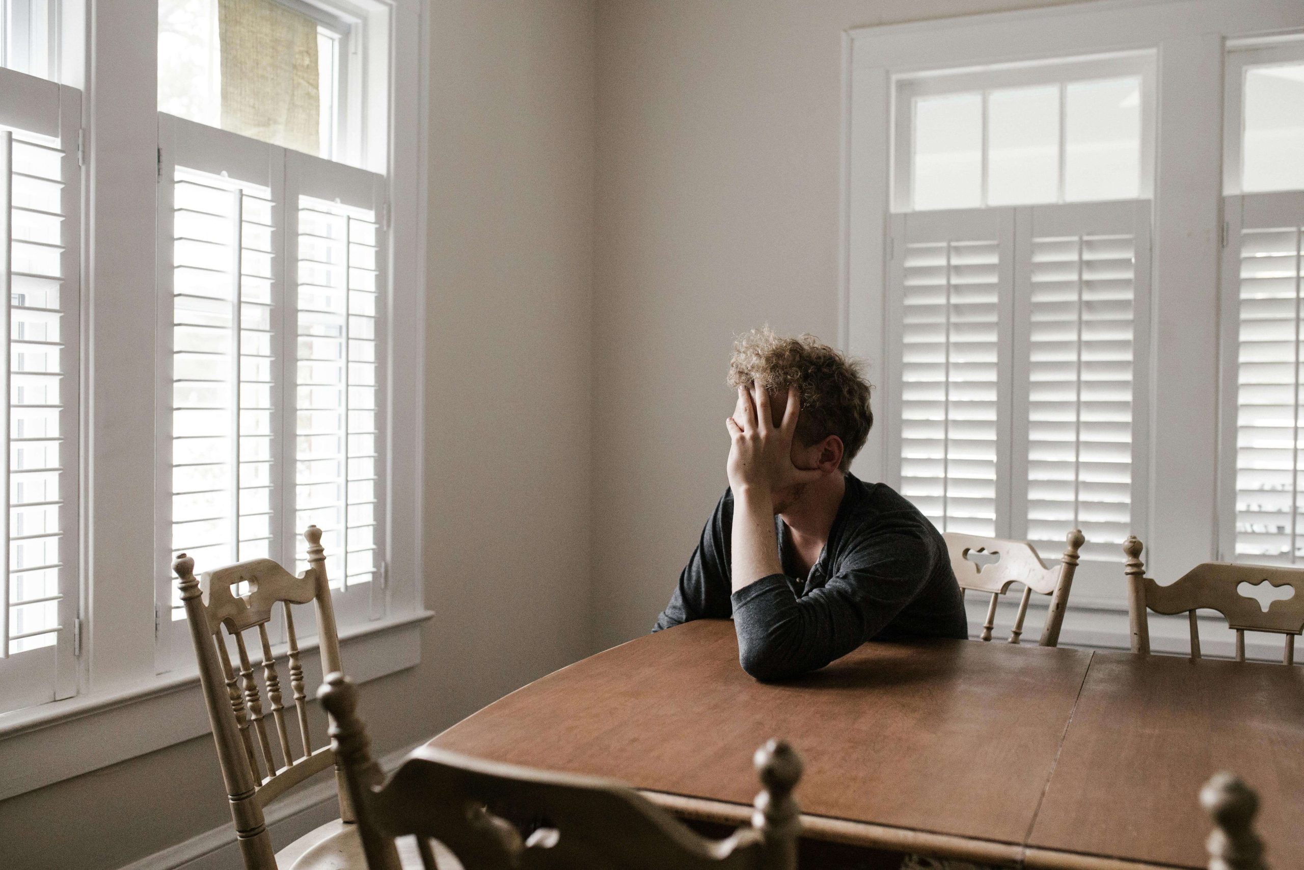 Young man experiencing emotional distress at home, symbolizing the need for psychiatric support and mental health services in Tempe, AZ.