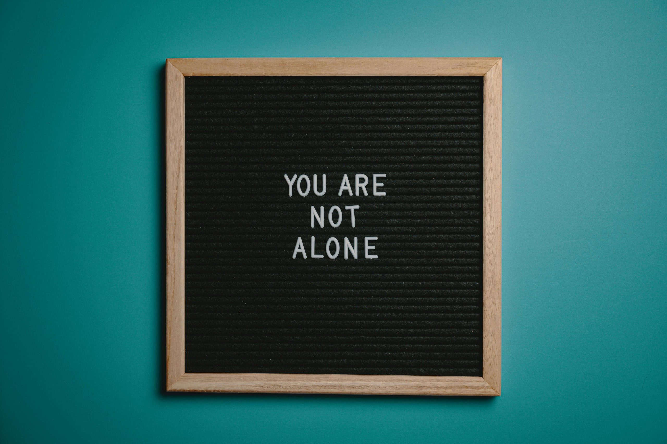 A motivational sign that reads 'You Are Not Alone'—a powerful reminder of the support offered through mental health treatment in Tempe, AZ.