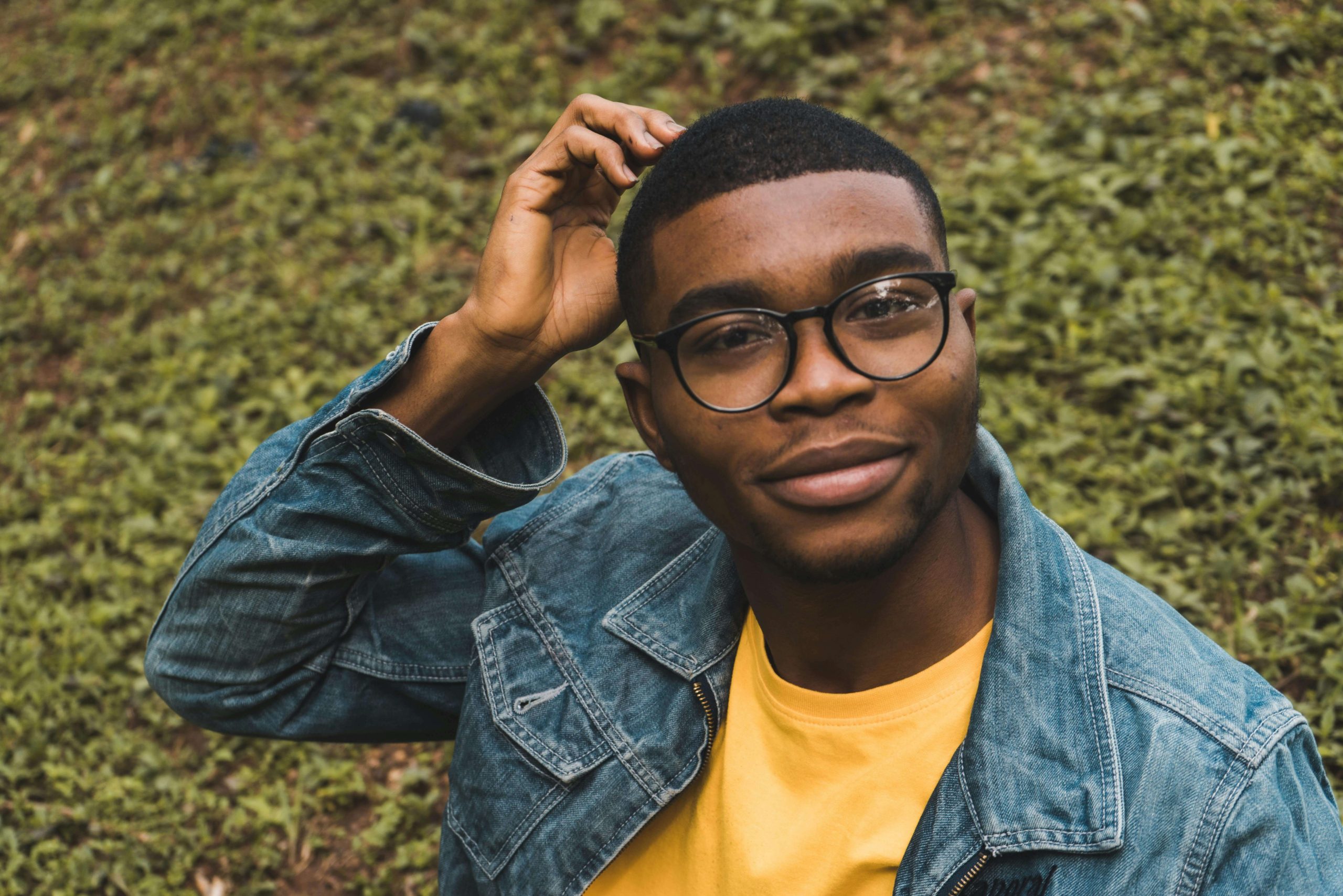 Young man sitting outdoors looking thoughtful, representing mood changes and how psychiatry in Tempe AZ supports mental health.