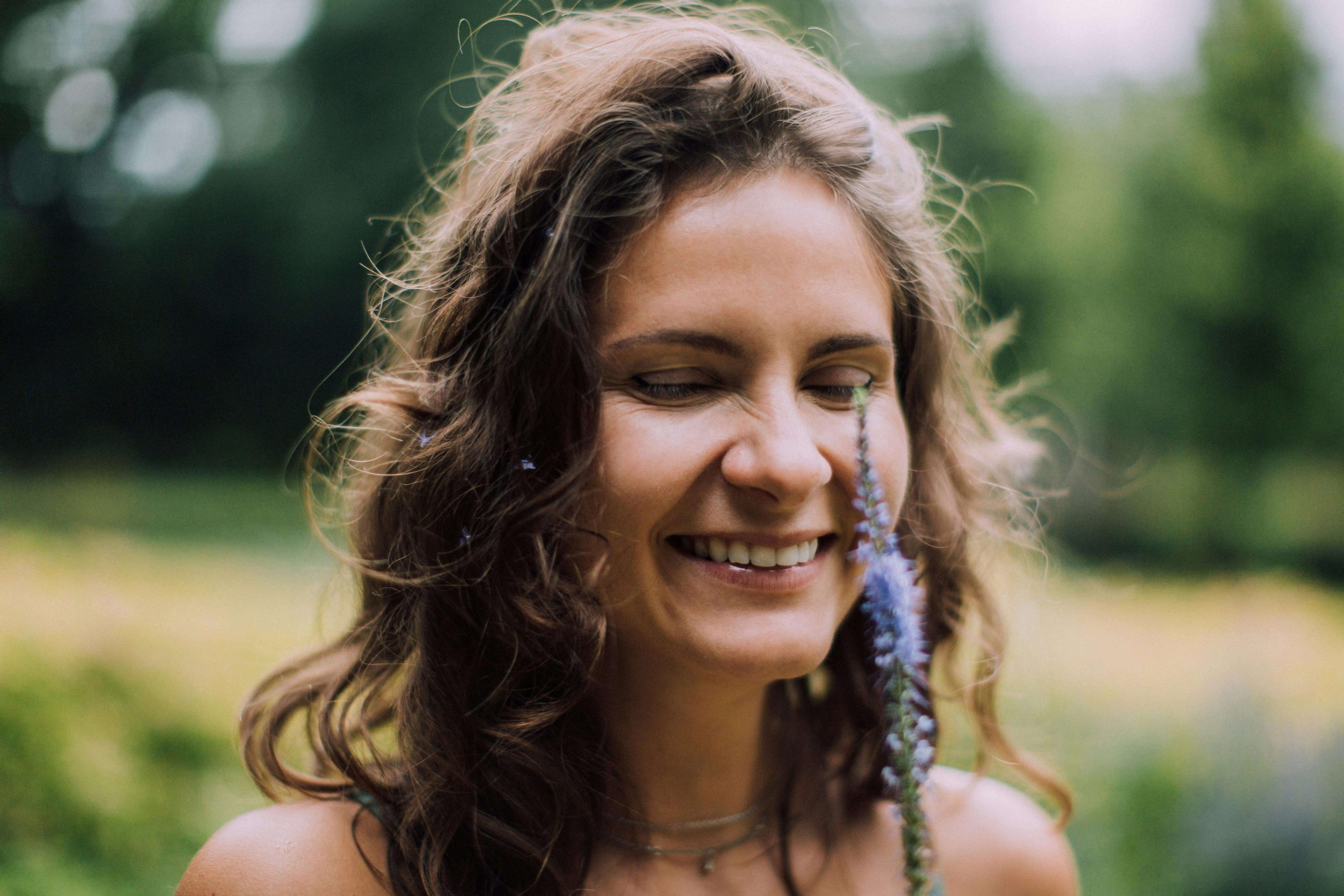 Smiling woman enjoying a moment in nature, representing hope and recovery through behavioral health in Tempe, AZ for seasonal affective disorder.