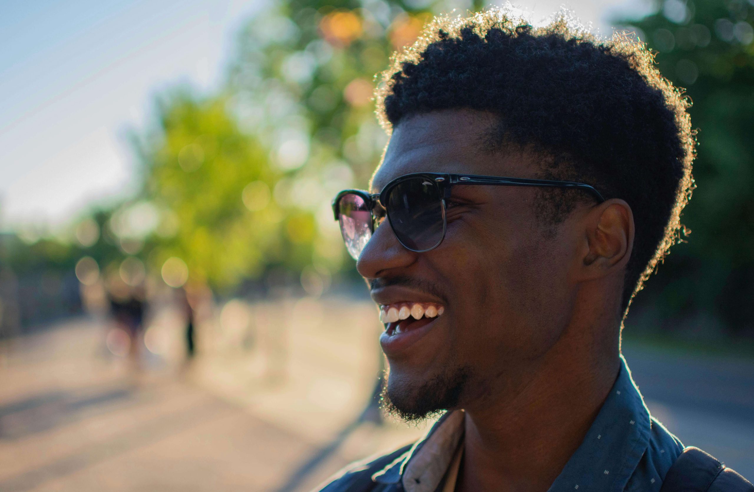 Man smiling and relaxed outside on a sunny day, illustrating the positive outcomes of psychiatric care in Tempe for anxiety and depression.