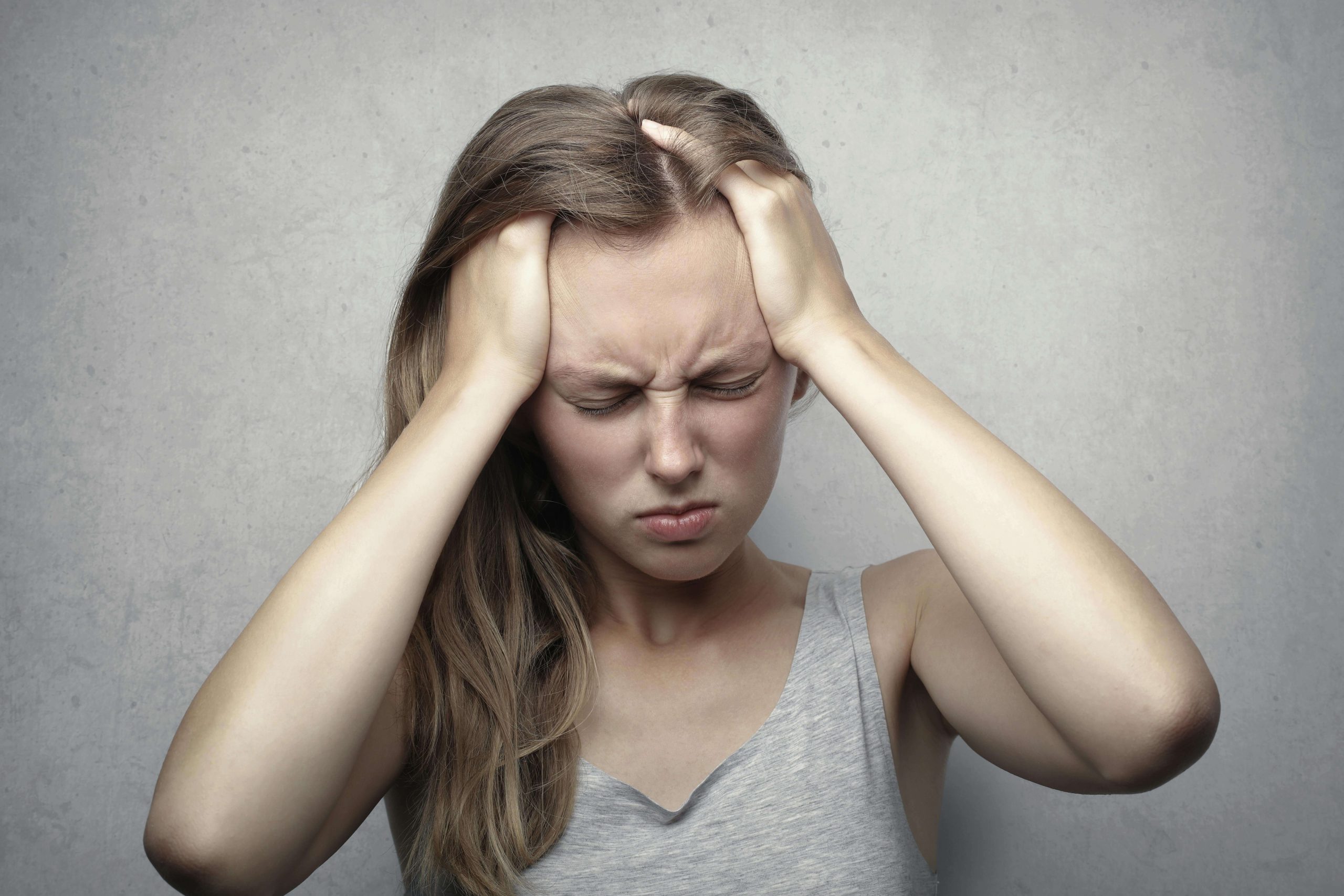 Frustrated Woman - ketamine infusion therapy tempe az - ketamine infusion therapy arizona - medication management tempe az - phx - phoenix - gilbert - scottsdale - mesa - arizona Woman holding her head in distress, representing the emotional exhaustion that may lead someone to explore ketamine infusion therapy in Tempe, AZ.