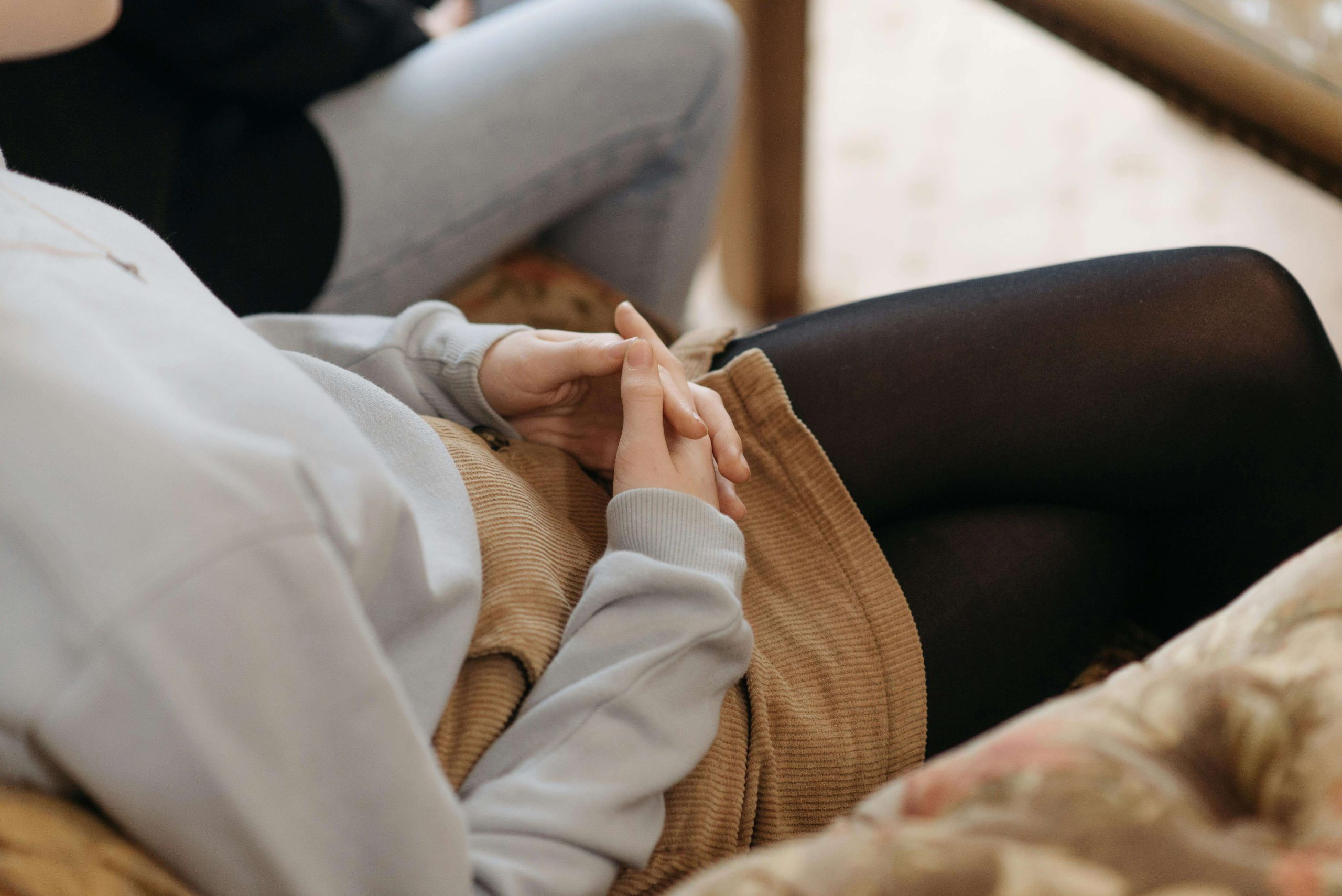 Close-up of a person with clasped hands in a therapy session, representing anxiety and support from a psychiatrist in Tempe, AZ