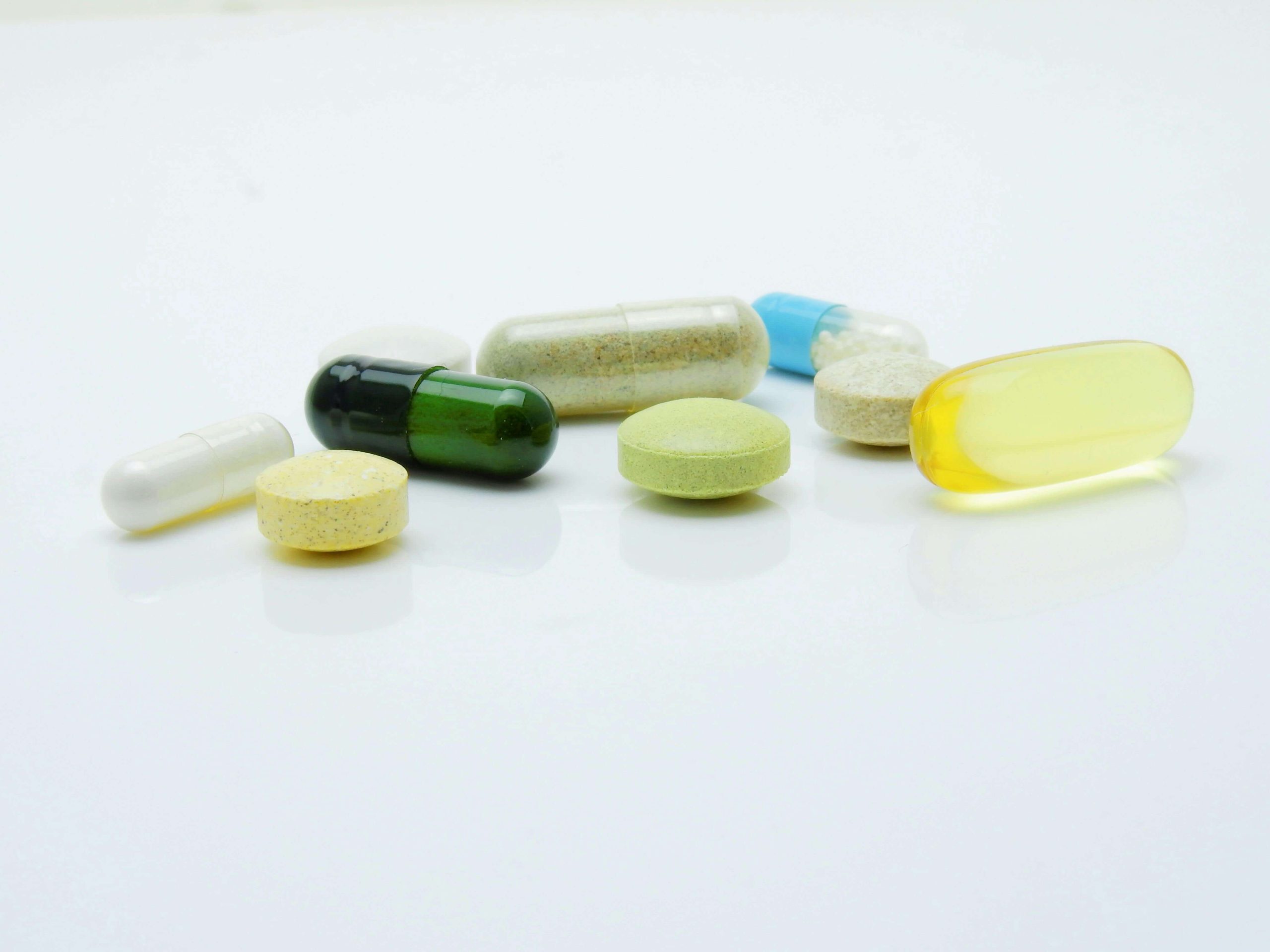 A variety of colorful pills and supplements, representing medication management for mental health in Tempe, AZ.