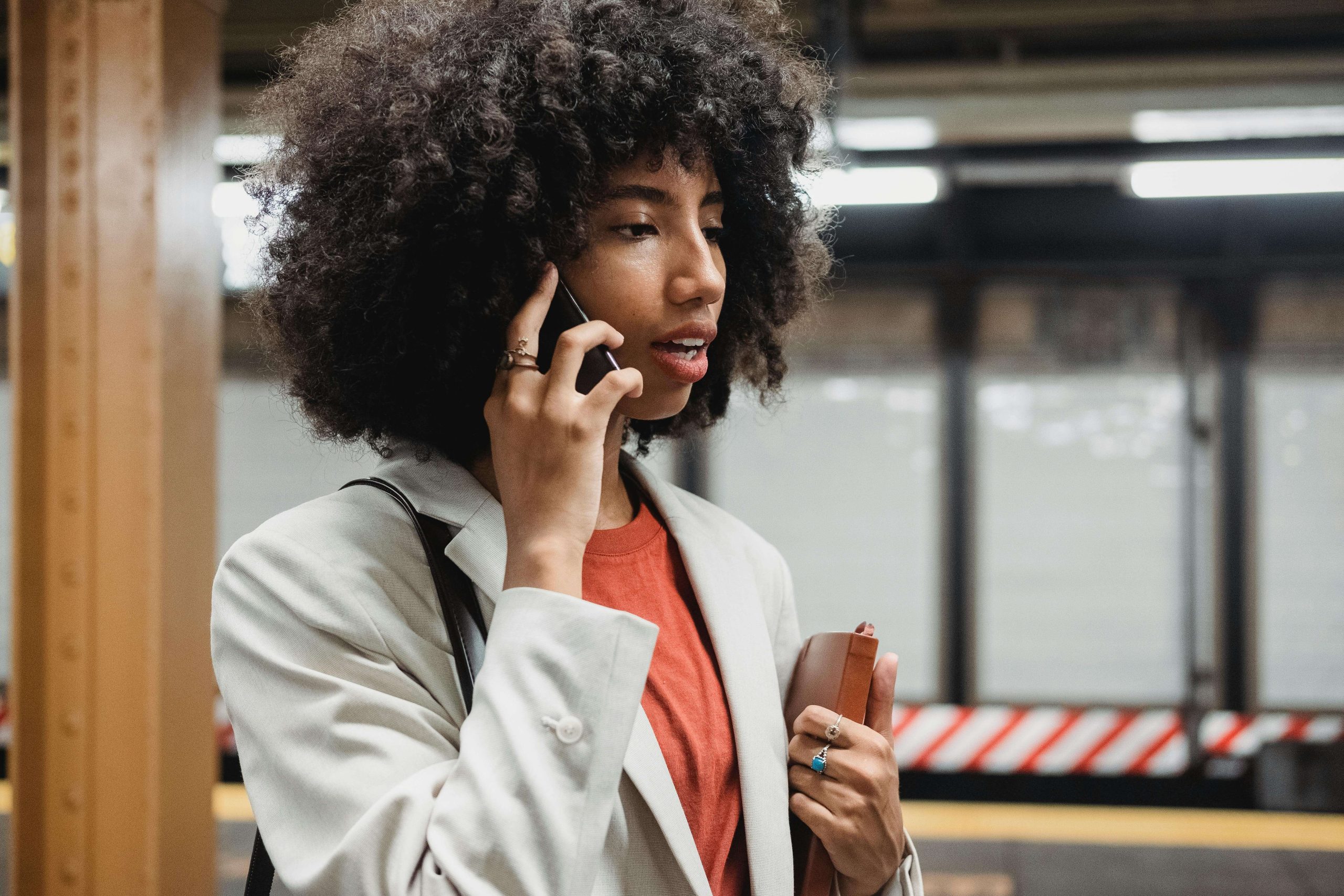 Woman on Phone - ketamine infusion therapy tempe az - ketamine infusion arizona - ketamine clinic arizona - phx - phoenix - gilbert - scottsdale - mesa - arizona Woman talking on the phone in a subway station, considering new mental health options like ketamine infusion therapy in Tempe, AZ.