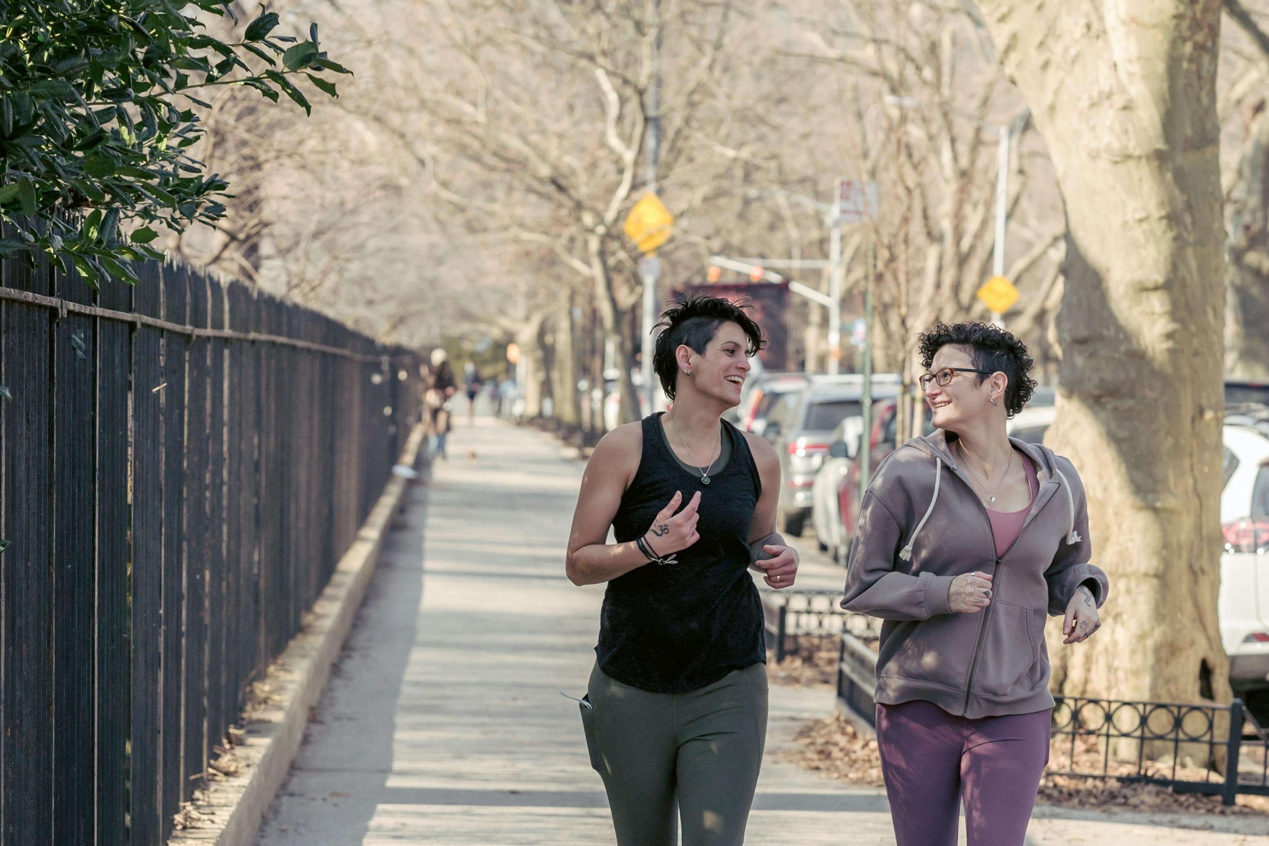 Two friends jogging outdoors, symbolizing healthy coping strategies supported by a psychiatrist in Tempe, AZ for dual diagnosis clients.